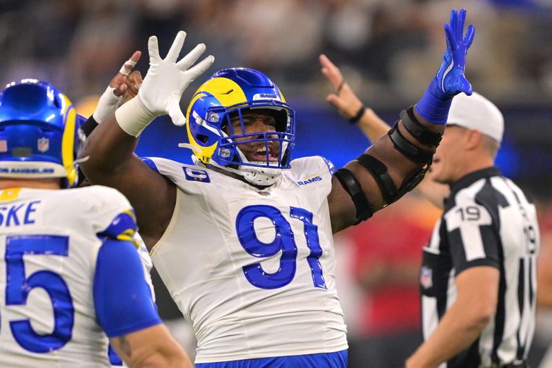 Nov 23, 2025; Inglewood, California, USA; Los Angeles Rams defensive end Kobie Turner (91) celebrates after a sack of Tampa Bay Buccaneers quarterback Baker Mayfield (6) in the first half at SoFi Stadium. Mandatory Credit: Jayne Kamin-Oncea-Imagn Images