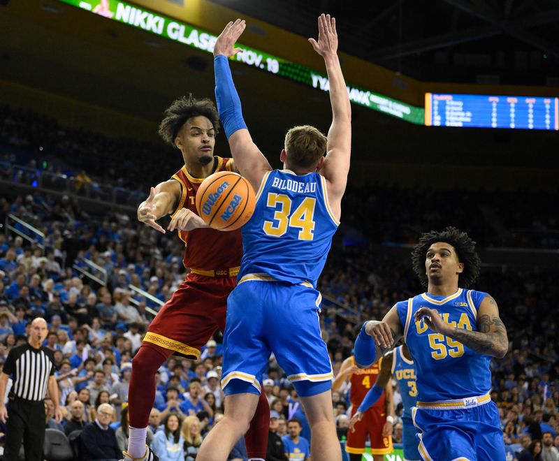 Feb 24, 2026; Los Angeles, California, USA; Southern California Trojans forward Terrance Williams II (5) wraps a pass around UCLA Bruins forward Tyler Bilodeau (34) during the first half at Pauley Pavilion presented by Wescom Financial. Mandatory Credit: Robert Hanashiro-Imagn Images