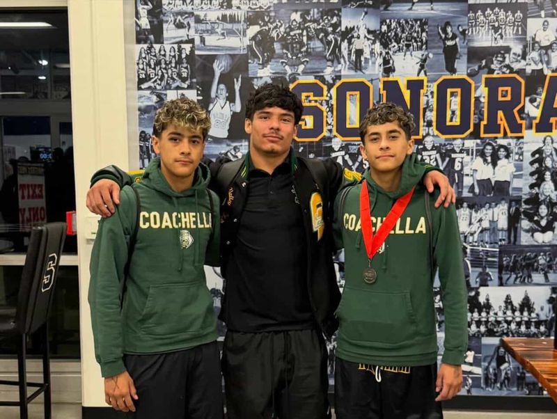 Coachella Valley wrestler Ivan Angulo (right) wears his medal that signifies he made it to the state meet by finishing second at the Masters Meet. He is joined by teammates Abel Angulo (left) and Ivan Camargo (middle).