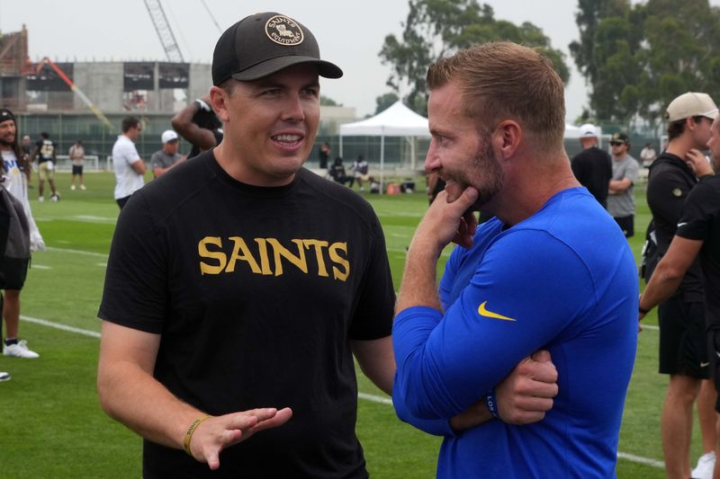 Aug 14, 2025; Carson, CA, USA; New Orleans Saints head coach Kellen Moore (left) talks with Los Angeles Rams head coach Sean McVay during a joint practice at the Dignity Health Sports Park. Mandatory Credit: Kirby Lee-Imagn Images