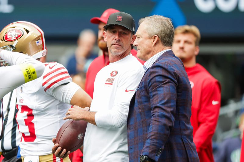 Sep 7, 2025; Seattle, Washington, USA; San Francisco 49ers general manager John Lynch, right, talks with head coach Kyle Shanahan during pregame warmups against the Seattle Seahawks at Lumen Field. Mandatory Credit: Joe Nicholson-Imagn Images
