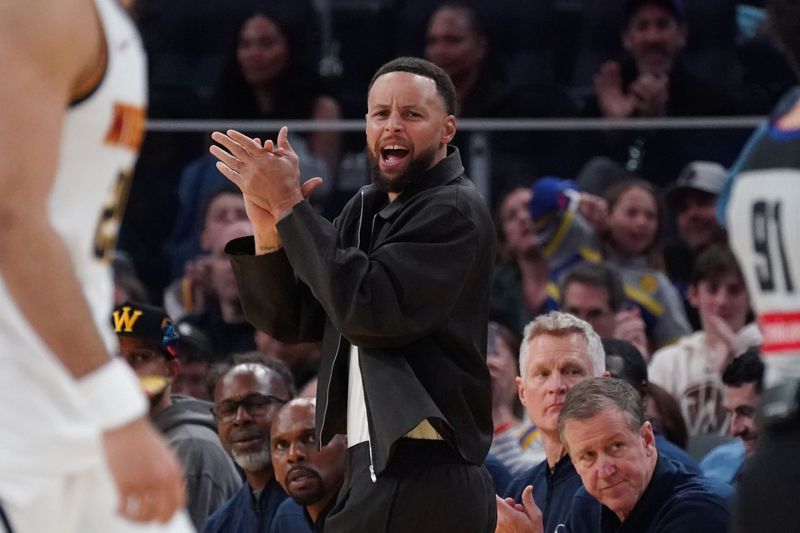 Feb 22, 2026; San Francisco, California, USA; Golden State Warriors guard Stephen Curry (30) cheers from the bench during a game against the Denver Nuggets in the third quarter at Chase Center. Mandatory Credit: David Gonzales-Imagn Images