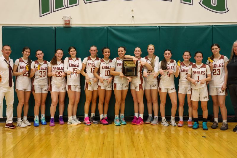 The West Valley girls basketball team smiles with its championship plaque shortly after defeating U-Prep 44-30. Feb. 28, 2026.