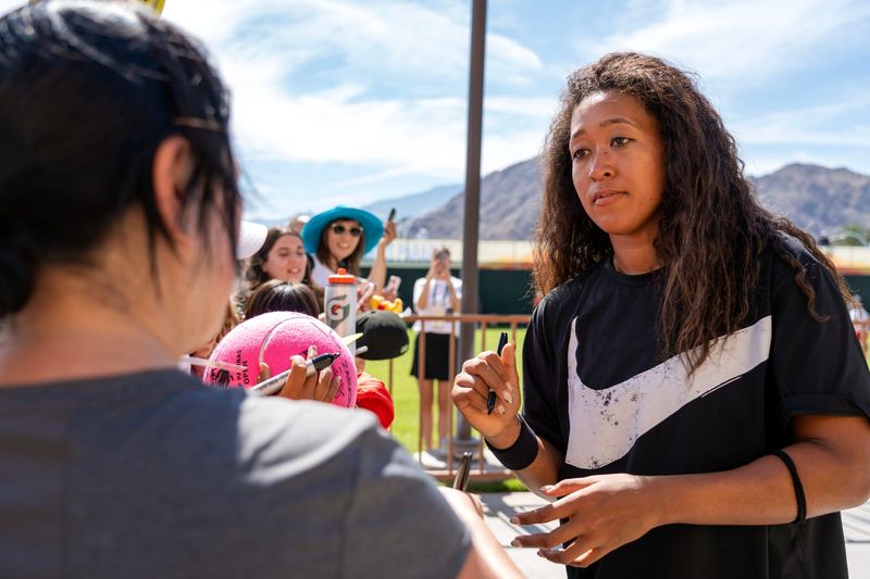 Naomi Osaka signs her autograph for fans after a practice session during the BNP Paribas Open in Indian Wells, Calif., on Monday, March 2, 2026.