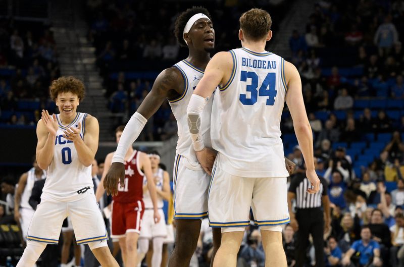 Mar 3, 2026; Los Angeles, California, USA; UCLA Bruins forward Tyler Bilodeau (34) chest dumps teammate Eric Dailey Jr. (3) after hitting a 3-point shot during the second} half at Pauley Pavilion presented by Wescom Financial. Mandatory Credit: Robert Hanashiro-Imagn Images