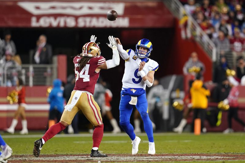 Dec 12, 2024; Santa Clara, California, USA; Los Angeles Rams quarterback Matthew Stafford (9) throws a pass over San Francisco 49ers linebacker Fred Warner (54) in the third quarter at Levi's Stadium. Mandatory Credit: Cary Edmondson-Imagn Images