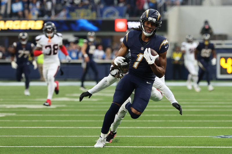 Dec 27, 2025; Inglewood, California, USA; Los Angeles Chargers wide receiver Quentin Johnston (1) runs after the catch as Houston Texans cornerback Tremon Smith (11) defends during the first half at SoFi Stadium. Mandatory Credit: Kiyoshi Mio-Imagn Images