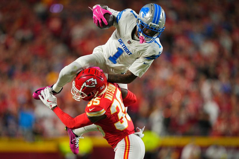 Oct 12, 2025; Kansas City, Missouri, USA; Detroit Lions wide receiver Jameson Williams (1) leaps over Kansas City Chiefs cornerback Jaylen Watson (35) during the first half at GEHA Field at Arrowhead Stadium. Mandatory Credit: Jay Biggerstaff-Imagn Images