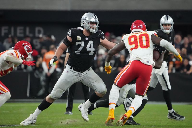 Nov 26, 2023; Paradise, Nevada, USA; Las Vegas Raiders offensive tackle Kolton Miller (74) defends against Kansas City Chiefs defensive end Charles Omenihu (90) in the second half at Allegiant Stadium. Mandatory Credit: Kirby Lee-USA TODAY Sports