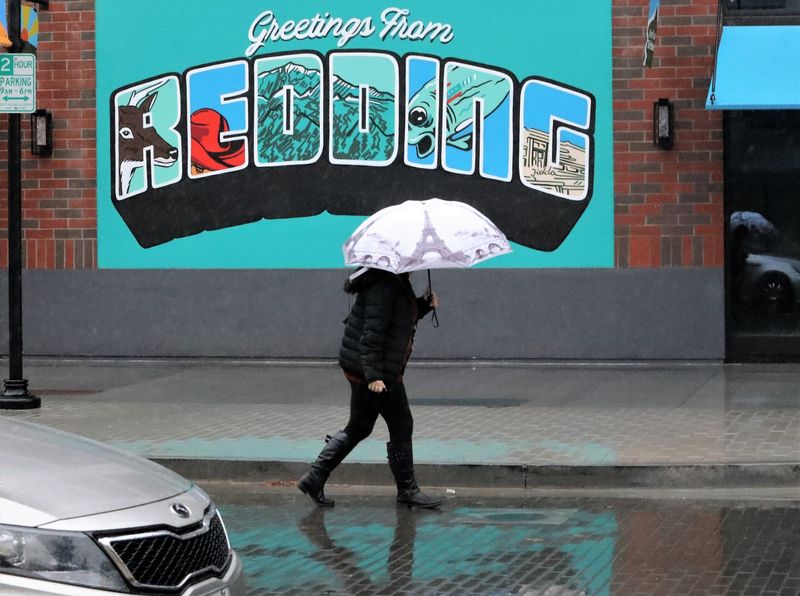 Ilena Shortt of Redding holds an umbrella as she walks to her car in the rain along Market Street on Wednesday, Dec. 15, 2021. Rain is in the forecast for Redding through Thursday, according to the National Weather Service.
