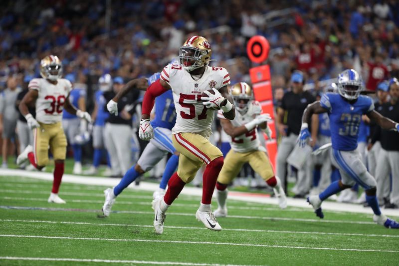 San Francisco 49ers linebacker Dre Greenlaw returns an interception back for a touchdown against the Detroit Lions on Sunday, Sept. 12, 2021 at Ford Field.