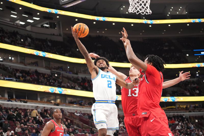 Mar 12, 2026; Chicago, IL, USA; Rutgers Scarlet Knights guard Harun Zrno (13) defends UCLA Bruins guard Donovan Dent (2) during the first half at United Center. Mandatory Credit: David Banks-Imagn Images