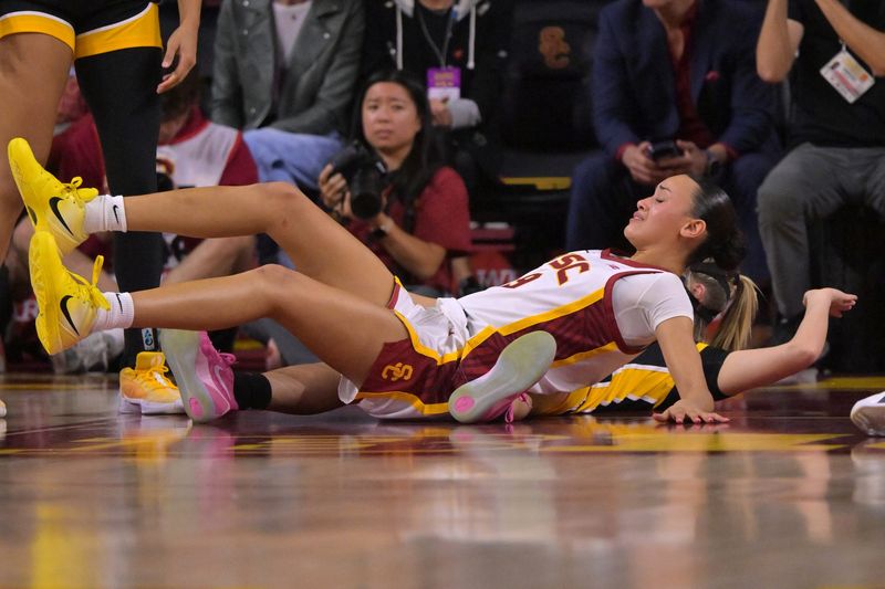 Jan 29, 2026; Los Angeles, California, USA; USC Trojans guard Jazzy Davidson (9) gets tangled up with Iowa Hawkeyes guard Callie Levin (32) in the second half at Galen Center. Mandatory Credit: Jayne Kamin-Oncea-Imagn Images