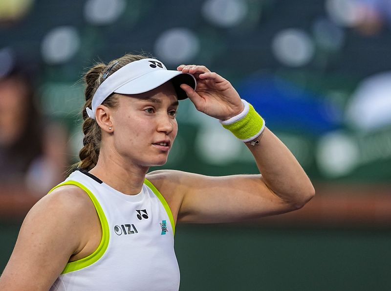 Elena Rybakina adjusts her visor after warming up with Elina Svitolina for their semifinal match at the BNP Paribas Open in Indian Wells, Calif., Friday, March 13, 2026.