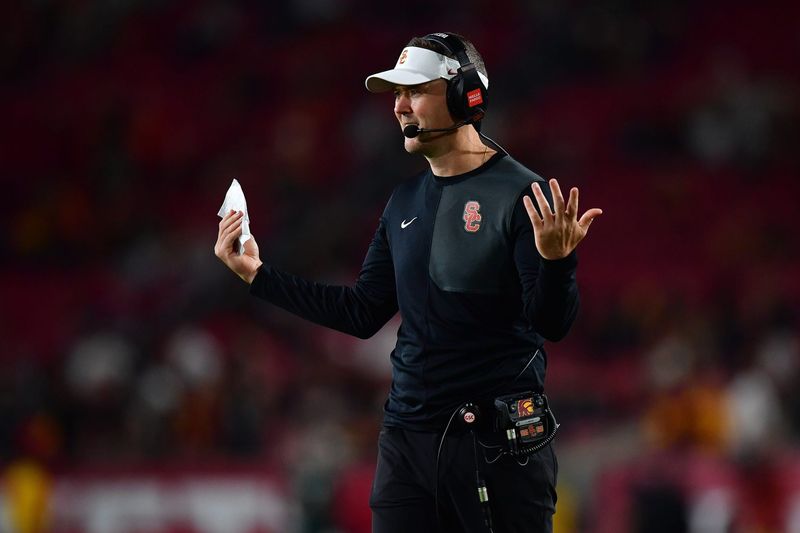 Sep 20, 2025; Los Angeles, California, USA; Southern California Trojans head coach Lincoln Riley watches game action against the Michigan State Spartans during the second half at the Los Angeles Memorial Coliseum. Mandatory Credit: Gary A. Vasquez-Imagn Images