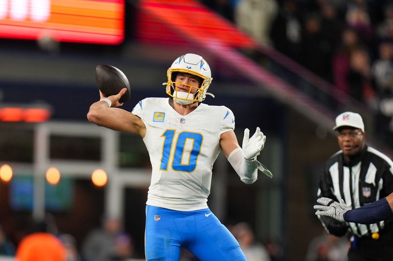 Jan 11, 2026; Foxborough, MA, USA; Los Angeles Chargers quarterback Justin Herbert (10) throws a pass during the third quarter against the New England Patriots in an AFC Wild Card Round game at Gillette Stadium. Mandatory Credit: David Butler II-Imagn Images