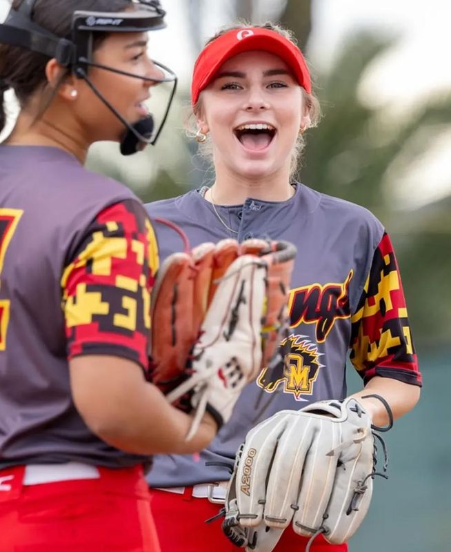 Oakdale senior Reese Donaldson, center, and teammate Jaelyn Lee, left, smile during a game in the 2025 season. Lee is now a freshman at the University of the Pacific.