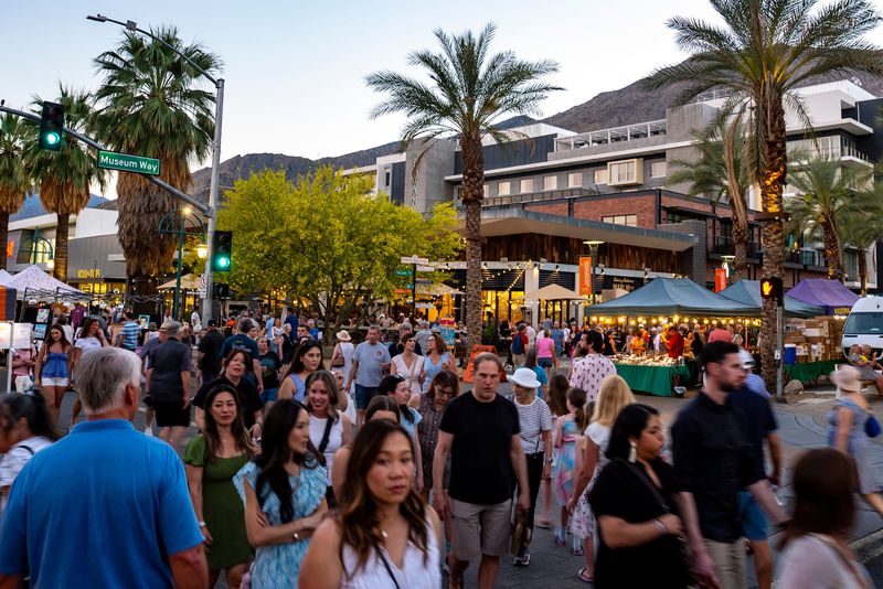 Tourists and locals check out the vendors and shops on Palm Canyon Drive during Village Fest in Palm Springs on Thursday, March 19, 2026.
