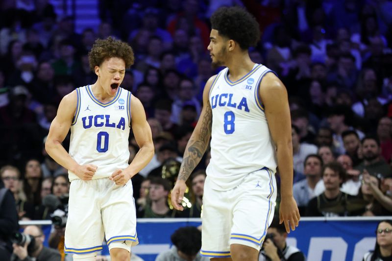 Mar 20, 2026; Philadelphia, PA, USA; UCLA Bruins guard Trent Perry (0) reacts with guard Eric Freeny (8) in the second half during a first round game of the men's 2026 NCAA Tournament at Xfinity Mobile Arena. Mandatory Credit: Bill Streicher-Imagn Images