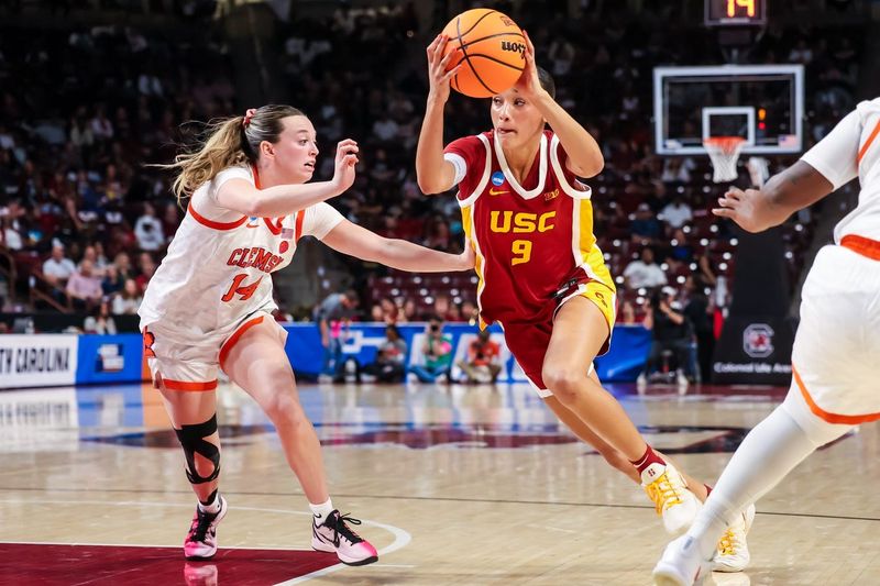 Mar 21, 2026; Columbia, South Carolina, USA; USC Trojans guard Jazzy Davidson (9) drives past Clemson Tigers guard Rachael Rose (14) in the first half at Colonial Life Arena. Mandatory Credit: Jeff Blake-Imagn Images