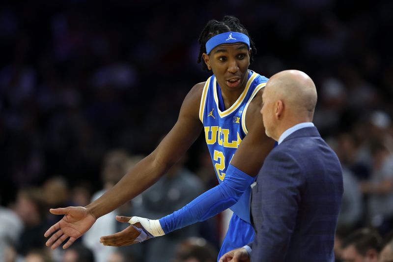 Mar 22, 2026; Philadelphia, PA, USA; UCLA Bruins center Steven Jamerson II (24) reacts with head coach Mick Cronin in the first half during a second round game of the men's 2026 NCAA Tournament at Xfinity Mobile Arena. Mandatory Credit: Bill Streicher-Imagn Images