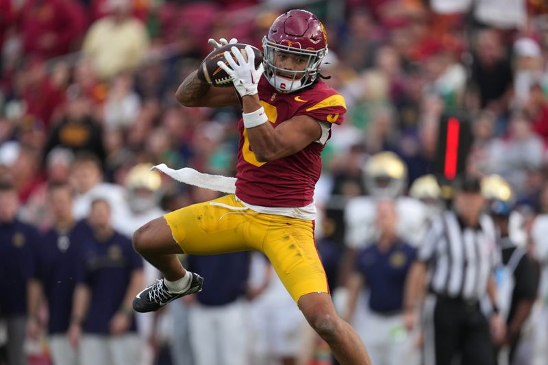 Nov 30, 2024; Los Angeles, California, USA; Southern California Trojans wide receiver Makai Lemon (6) catches the ball against the Notre Dame Fighting Irish in the second half at United Airlines Field at Los Angeles Memorial Coliseum. Mandatory Credit: Kirby Lee-Imagn Images