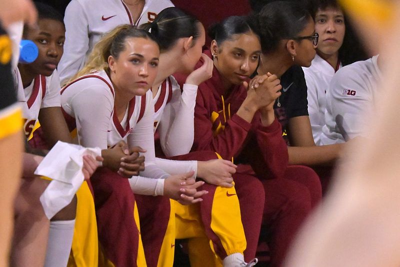 Jan 29, 2026; Los Angeles, California, USA; USC Trojans guard Juju Watkins (12), in red jacket, looks on from the bench in the second half against the Iowa Hawkeyes at Galen Center. Mandatory Credit: Jayne Kamin-Oncea-Imagn Images