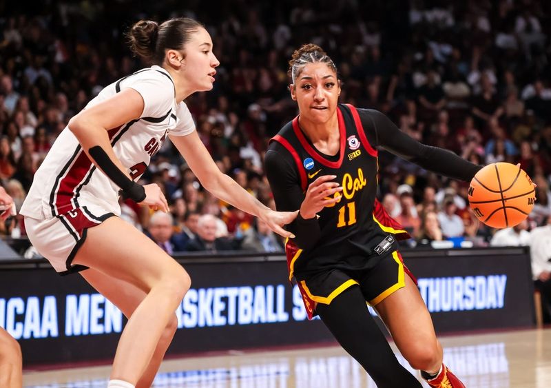 Mar 23, 2026; Columbia, South Carolina, USA; USC Trojans guard Kennedy Smith (11) drives around South Carolina Gamecocks forward Alicia Tournebize (31) in the first half at Colonial Life Arena. Mandatory Credit: Jeff Blake-Imagn Images