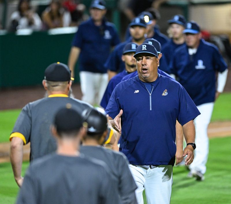 Redwood Head Coach Dan Hydash leads his team out for hand shakes after their game against Golden West in an East Yosemite League high school baseball game on Wednesday, March 25, 2026 at Valley Strong Ball Park.