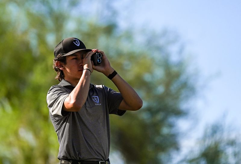 Xavier Prep's Ayden Rosales checks his rangefinder before teeing off on three at Desert Willow golf resort in Palm Desert, Calif., Thursday, March 26, 2026.