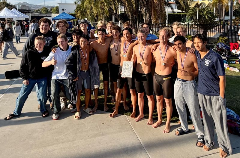 The Camarillo High boys swimming team poses with the championship plaque after winning the team title at the Ventura County Swimming Championships on Thursday, March 26, 2026, at the Ventura Aquatic Center.