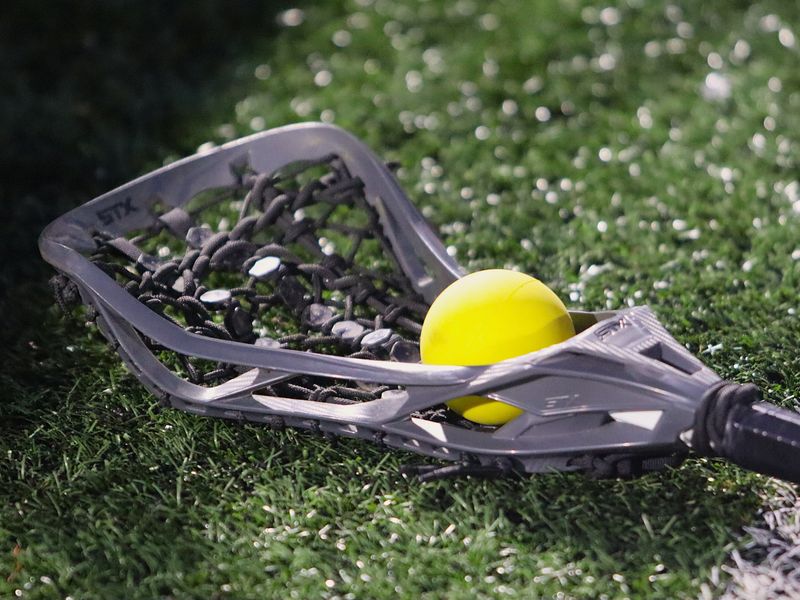 A girls lacrosse stick lies on the turf cradling a ball at Aleixo "Tiger"Field in Taunton, MA on March 27, 2026.