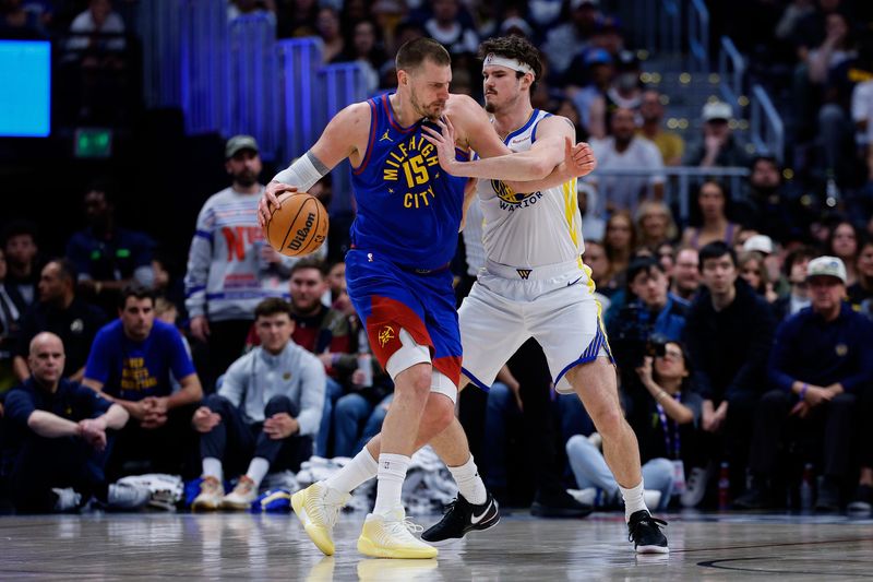 Mar 29, 2026; Denver, Colorado, USA; Denver Nuggets center Nikola Jokic (15) controls the ball as Golden State Warriors center Quinten Post (21) guards in the second quarter at Ball Arena. Mandatory Credit: Isaiah J. Downing-Imagn Images
