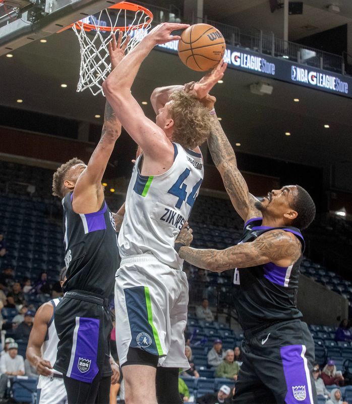 Stockton Kings’ Dexter Dennis, left and DaQuan Jefferies defend the basket against Iowa Wolves’ Rocco Zikarsky during the 2026 NBA G League playoff quarterfinal at Adventist Health Arena in downtown Stockton on Apr. 1, 2026. The Kings won 116-104.