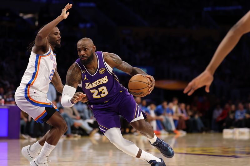 Feb 9, 2026; Los Angeles, California, USA; Los Angeles Lakers forward LeBron James (23) drives to the basket against Oklahoma City Thunder guard Cason Wallace (22) during the third quarter at Crypto.com Arena. Mandatory Credit: Kiyoshi Mio-Imagn Images
