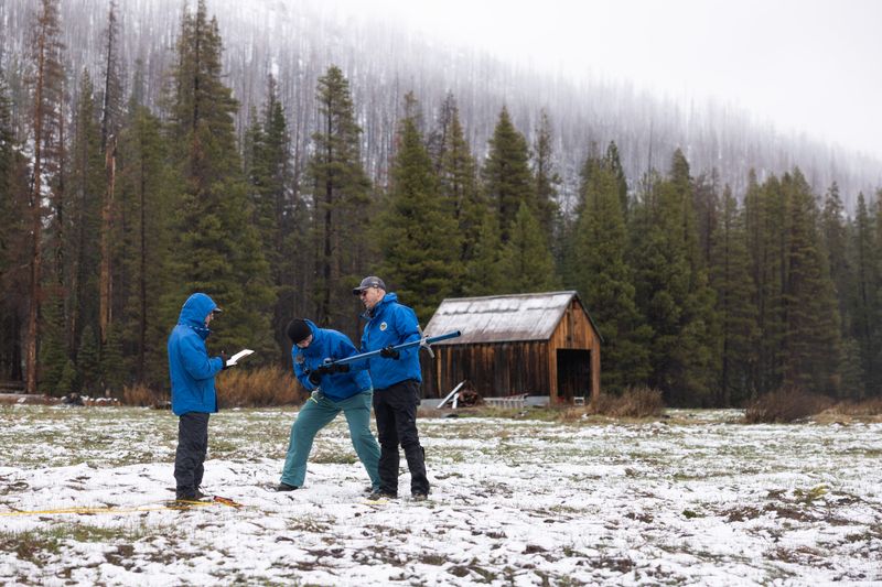 The California Department of Water Resources’ (from right) Jacob Kollen, Snow Surveys and Water Supply Forecasting Unit Water Resources Engineer, Jim Shannon, California Cooperative Snow Surveys Unit Manager, and Andy Reising, Snow Surveys and Water Supply Forecasting Unit Manager, conduct the fourth media snow survey of the 2026 season at Phillips Station in the Sierra Nevada. The snow survey is held approximately 90 miles east of Sacramento off Highway 50 in El Dorado County. Photo taken April 1, 2026.