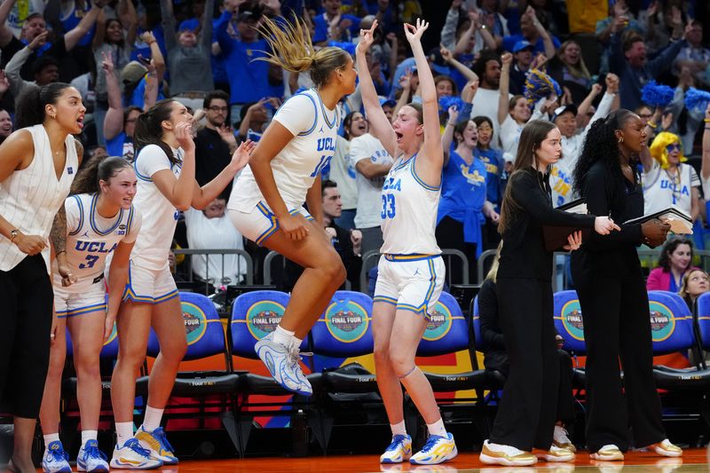 Apr 3, 2026; Phoenix, AZ, USA; UCLA Bruins forward Sienna Betts (16) and forward Amanda Muse (33) react with teammates on the bench during the second half of a semifinal of the Final Four of the women's 2026 NCAA Tournament against the Texas Longhorns at Mortgage Matchup Center. Mandatory Credit: Kirby Lee-Imagn Images