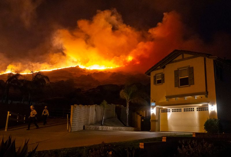 Cal Fire crews prepare to hold a line against the Spring Fire at the end of Durham Circle in Moreno Valley, Calif., Friday, April 3, 2026.