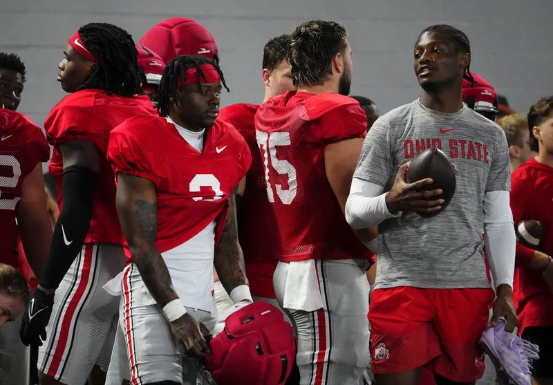 Ohio State Buckeyes running back Legend Bey (2) listens to former wide receiver Carnell Tate during Student Appreciation Day spring practice at the Woody Hayes Athletic Center on April 4, 2026.
