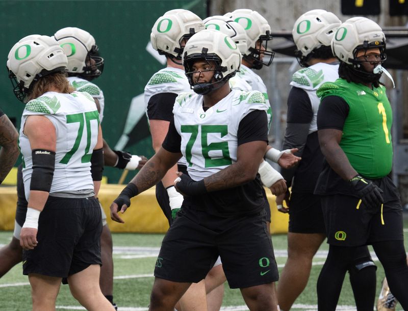 Oregonâ€™s Isaiah World, center, works out with the team during a practice session before the first-round CFP game against James Madison.