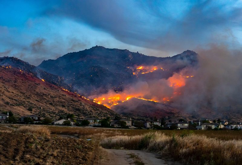 The Springs Fire burns in the hills above homes in Moreno Valley, Calif., Friday, April 3, 2026.