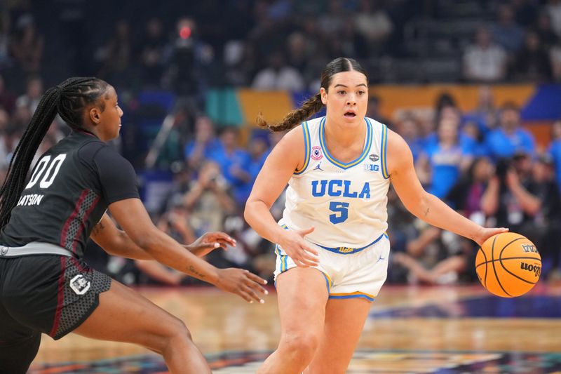 UCLA Bruins guard Charlisse Leger-Walker (5) controls the ball against South Carolina Gamecocks guard Ta'niya Latson (00) in the first half during the National Championship game of the women's 2026 NCAA Tournament at Mortgage Matchup Center.