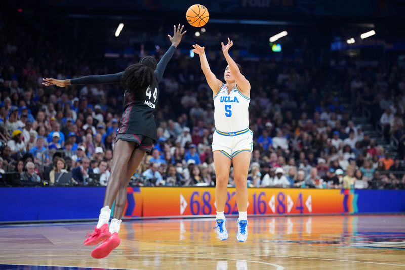 Apr 5, 2026; Phoenix, AZ, USA; UCLA Bruins guard Charlisse Leger-Walker (5) shoots against South Carolina Gamecocks guard Agot Makeer (44) in the first half during the National Championship game of the women's 2026 NCAA Tournament at Mortgage Matchup Center. Mandatory Credit: Kirby Lee-Imagn Images