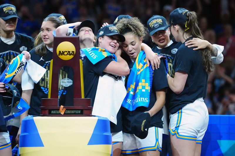 Apr 5, 2026; Phoenix, AZ, USA; UCLA Bruins guard Kiki Rice (1) celebrates on the podium with teammates after defeating the South Carolina Gamecocks during the National Championship game of the women's 2026 NCAA Tournament at Mortgage Matchup Center. Mandatory Credit: Kirby Lee-Imagn Images