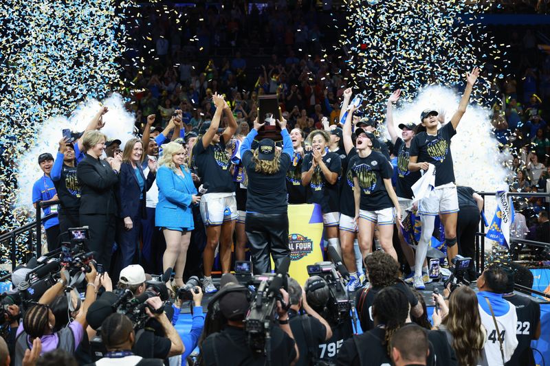 Apr 5, 2026; Phoenix, AZ, USA; (Editors Notes: Caption Correction) UCLA Bruins head coach Cori Close lifts the trophy after the National Championship game against the South Carolina Gamecocks of the women's 2026 NCAA Tournament at Mortgage Matchup Center. Mandatory Credit: Mark J. Rebilas-Imagn Images