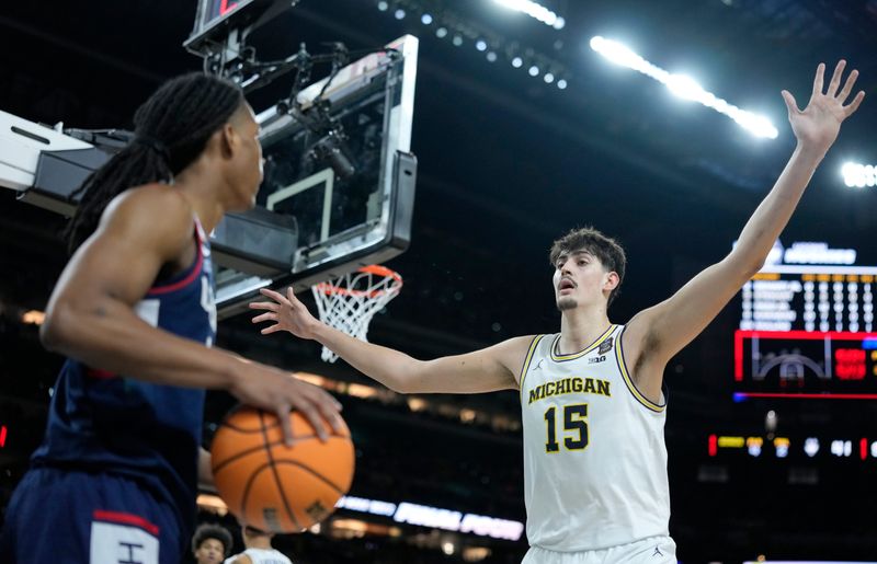 Michigan Wolverines center Aday Mara (15) guards UConn Huskies guard Silas Demary Jr. (2) on an inbound play Monday, April 6, 2026, during the NCAA men’s basketball national championship game at Lucas Oil Stadium in Indianapolis.