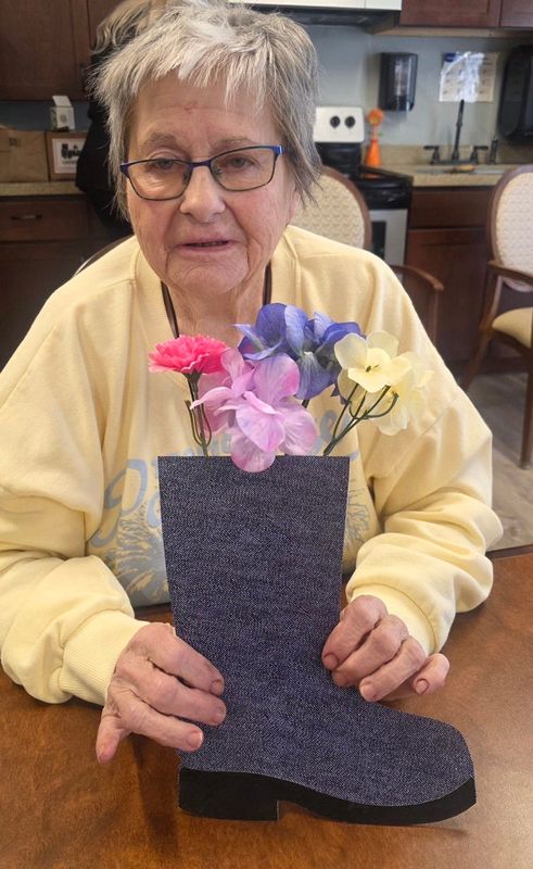 A group of seniors at Whispering Winds of Apple Valley used old boots as part of their National Plant a Flower Day celebration.