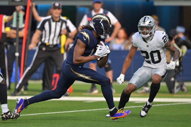 Nov 30, 2025; Inglewood, California, USA; Los Angeles Chargers wide receiver Quentin Johnston (1) makes a touchdown catch against the Las Vegas Raiders during the first half at SoFi Stadium. Mandatory Credit: Jayne Kamin-Oncea-Imagn Images