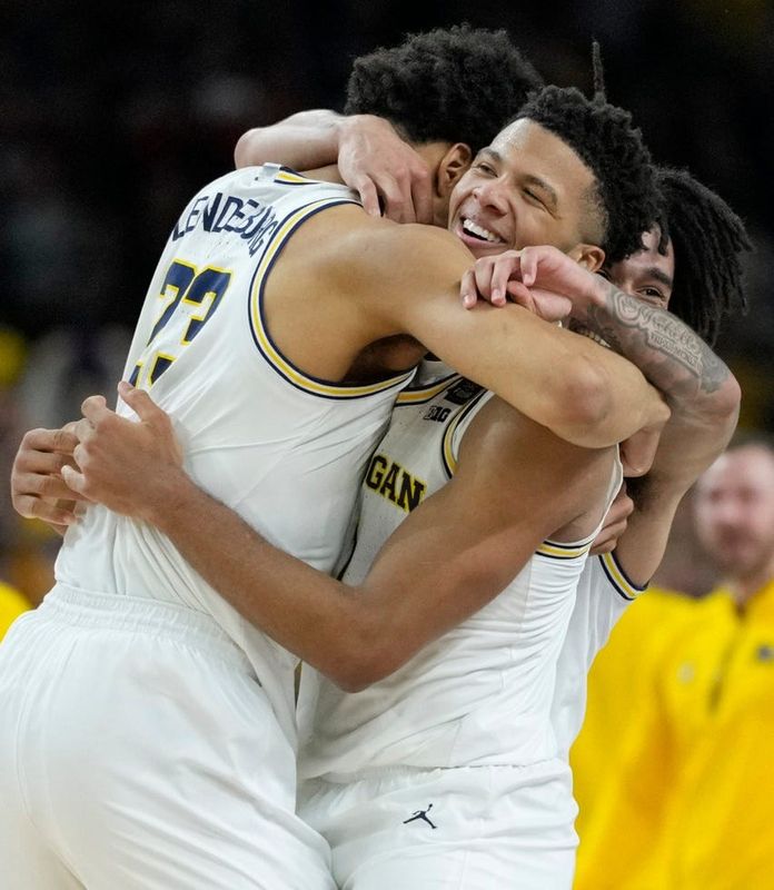 Michigan Wolverines forward Yaxel Lendeborg (23) and Wolverines guard Trey McKenney (1) celebrate their NCAA men's basketball tournament national championship victory Monday, April 6, 2026, after defeating the UConn Huskies 69-63 at Lucas Oil Stadium in Indianapolis.