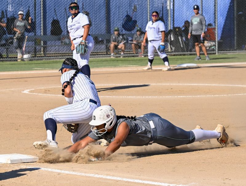 Dinuba's Cambria Alderete gets back to 1st on a pick off attempt against Redwood in non-league high school softball Tuesday, April 7, 2026.